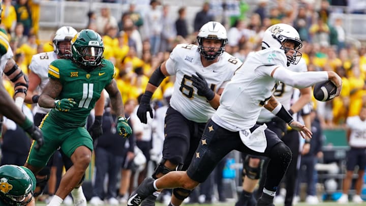 Nov 1, 2025; Waco, Texas, USA; UCF Knights quarterback Tayven Jackson (2) scrambles with the ball as Baylor Bears linebacker Keaton Thomas (11) defends during the second half at McLane Stadium. Mandatory Credit: Raymond Carlin III-Imagn Images
