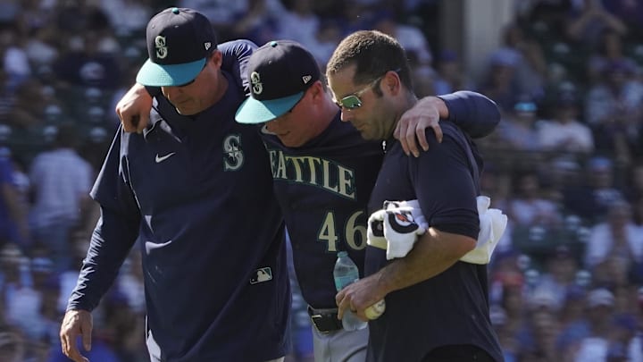 Seattle Mariners pitcher Trent Thornton (center) is helped off the field during a game against the Chicago Cubs on June 21 at Wrigley Field. Seattle Mariners pitcher Trent Thornton (center) is helped off the field during a game against the Chicago Cubs on June 21 at Wrigley Field.