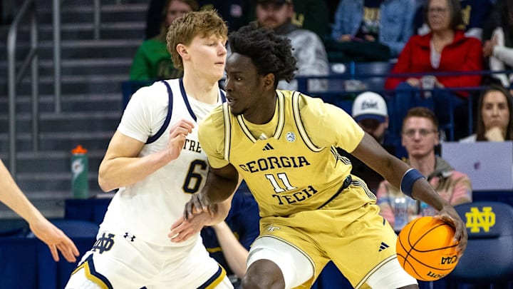 Feb 14, 2026; South Bend, Indiana, USA; Georgia Tech Yellow Jackets forward Baye Ndongo (11) controls the ball  against Notre Dame Fighting Irish forward Brady Koehler (6) during the first half at Purcell Pavilion at the Joyce Center. Mandatory Credit: Michael Caterina-Imagn Images