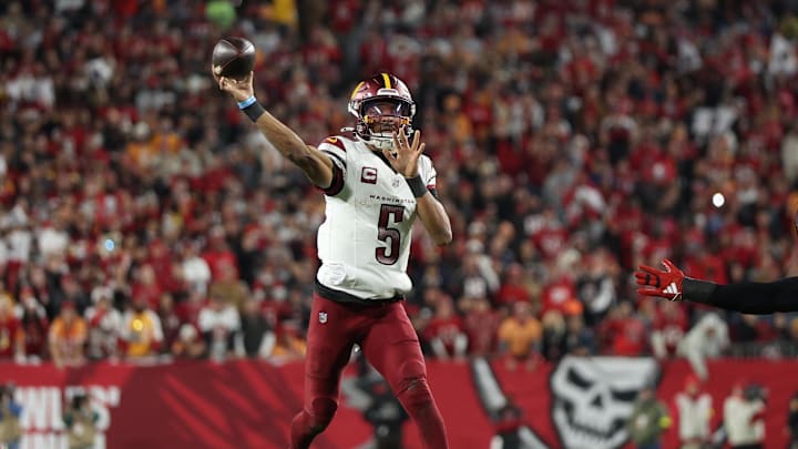 Jan 12, 2025; Tampa, Florida, USA; Washington Commanders quarterback Jayden Daniels (5) throws during the second quarter of a NFC wild card playoff against the Tampa Bay Buccaneers at Raymond James Stadium. Mandatory Credit: Nathan Ray Seebeck-Imagn Images