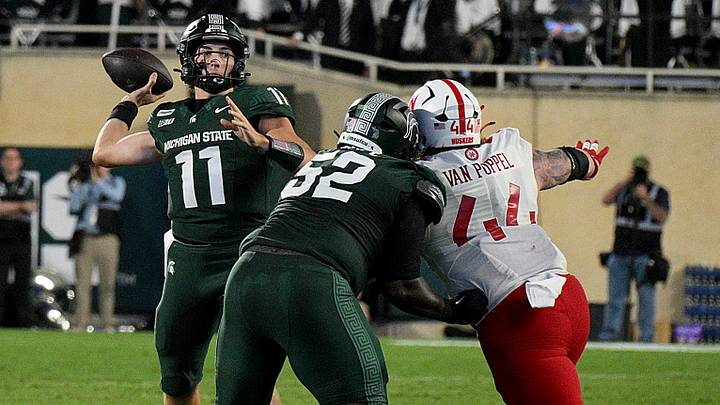 Nebraska's Riley Van Poppel pressures Michigan State quarterback Alessio Milivojevic at Spartan Stadium. 