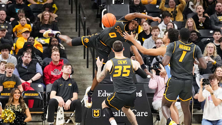 Dec 14, 2024; Columbia, Missouri, USA; Missouri Tigers guard Anthony Robinson II (0) dunks the ball as LIU Sharks guard Blake Lander (2) looks on during the first half at Mizzou Arena. Mandatory Credit: Denny Medley-Imagn Images Dec 14, 2024; Columbia, Missouri, USA; Missouri Tigers guard Anthony Robinson II (0) dunks the ball as LIU Sharks guard Blake Lander (2) looks on during the first half at Mizzou Arena. Mandatory Credit: Denny Medley-Imagn Images
