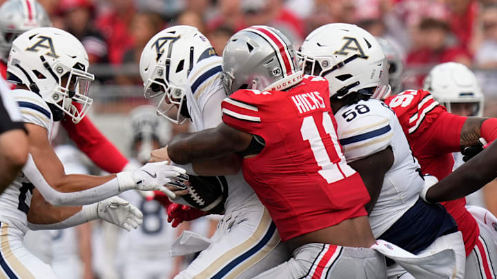 Aug 31, 2024; Columbus, OH, USA; Ohio State Buckeyes linebacker C.J. Hicks (11) sacks Akron Zips quarterback Ben Finley (10) during the first half of the NCAA football game at Ohio Stadium.