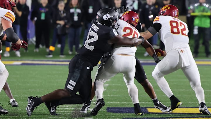 West Virginia defensive lineman Asani Redwood tackles Iowa State running back Carson Hansen.