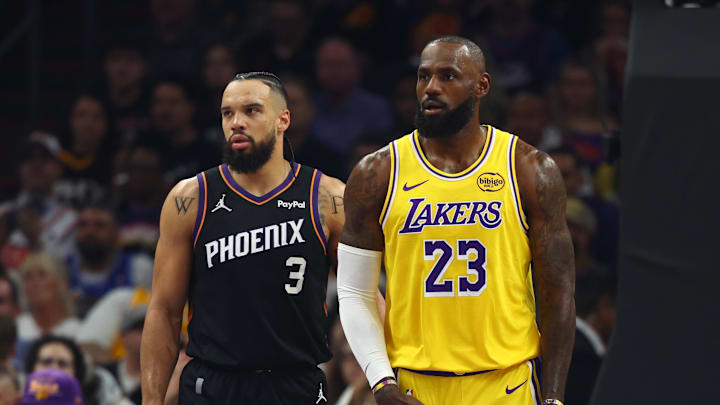Dec 23, 2025; Phoenix, Arizona, USA; Los Angeles Lakers forward LeBron James (23) against Phoenix Suns forward Dillon Brooks (3) at Mortgage Matchup Center. 
