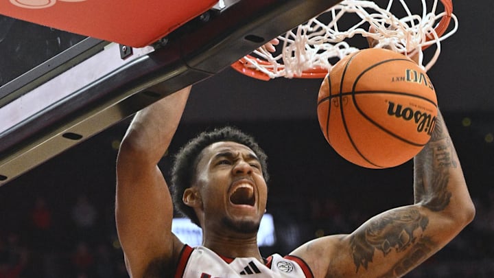 Jan 7, 2025; Louisville, Kentucky, USA; Louisville Cardinals forward James Scott (0) dunks against the Clemson Tigers during the second half at KFC Yum! Center. Louisville defeated Clemson 74-64.