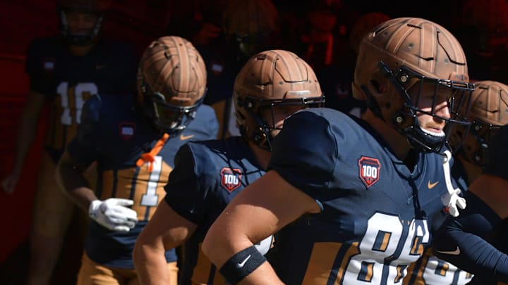 Oct 19, 2024; Champaign, Illinois, USA;  Illinois Fighting Illini players wear the throwback helmets and uniforms in honor of legendary Red Grange and the 100th anniversary of Memorial Stadium before the game against the Michigan Wolverines. Mandatory Credit: Ron Johnson-Imagn Images