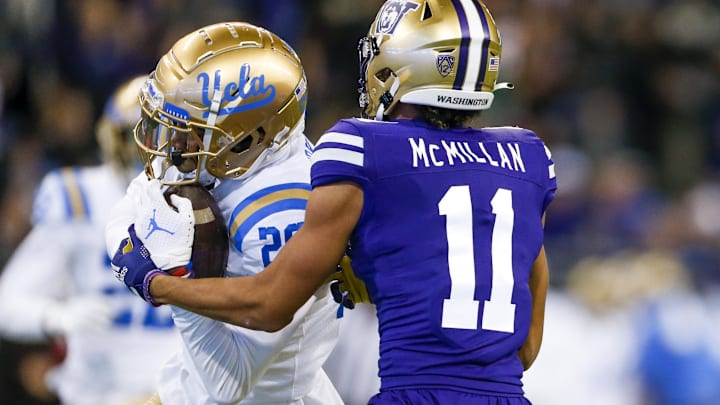 Oct 16, 2021; Seattle, Washington, USA; UCLA Bruins defensive back Devin Kirkwood (26) intercepts a pass intended for Washington Huskies wide receiver Jalen McMillan (11) during the fourth quarter at Alaska Airlines Field at Husky Stadium. Mandatory Credit: Joe Nicholson-Imagn Images