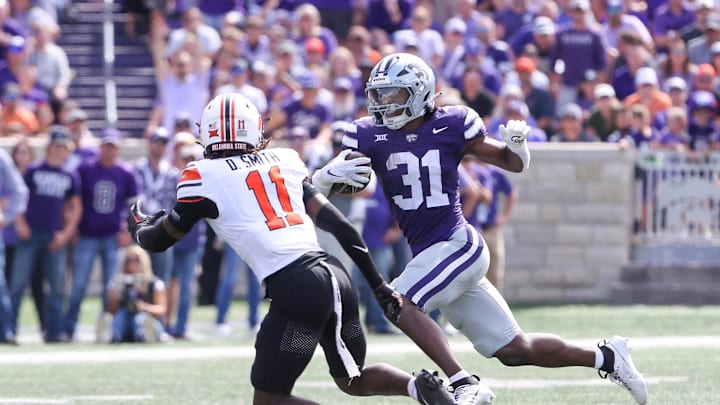 Sep 28, 2024; Manhattan, Kansas, USA; Kansas State Wildcats running back DJ Giddens (31) runs the ball against Oklahoma State Cowboys safety Dylan Smith (11) during the third quarter at Bill Snyder Family Football Stadium. Mandatory Credit: Scott Sewell-Imagn Images Sep 28, 2024; Manhattan, Kansas, USA; Kansas State Wildcats running back DJ Giddens (31) runs the ball against Oklahoma State Cowboys safety Dylan Smith (11) during the third quarter at Bill Snyder Family Football Stadium. Mandatory Credit: Scott Sewell-Imagn Images