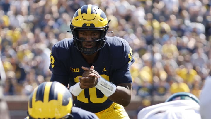 Michigan Wolverines quarterback Alex Orji (10) gets set to run a play in the second half against the Colorado State Rams at Michigan Stadium; Sep 3, 2022; Ann Arbor, Michigan, USA