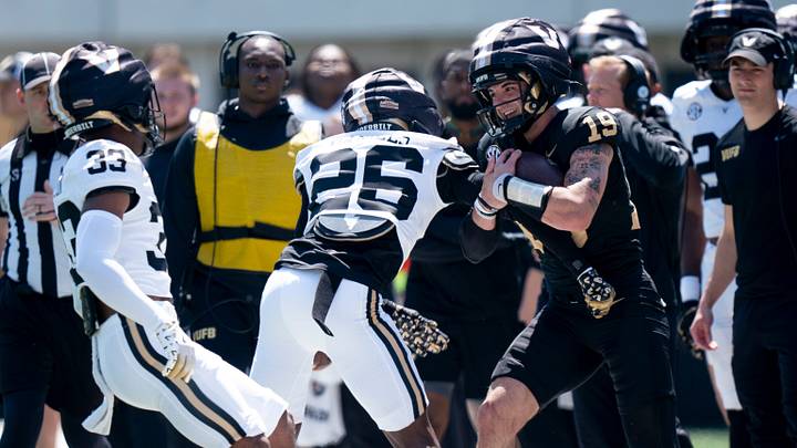 Vanderbilt quarterback Blaze Berlowitz (19) is knocked out of bounds by Vanderbilt cornerback Cayden Daniels (26) during the Vanderbilt Football Black and Gold Spring Game at FirstBank Stadium in Nashville, Tenn., Saturday, April 12, 2025. Vanderbilt quarterback Blaze Berlowitz (19) is knocked out of bounds by Vanderbilt cornerback Cayden Daniels (26) during the Vanderbilt Football Black and Gold Spring Game at FirstBank Stadium in Nashville, Tenn., Saturday, April 12, 2025.