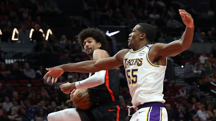 Apr 13, 2025; Portland, Oregon, USA; Portland Trail Blazers guard Matisse Thybulle (4) grabs a rebound against Los Angeles Lakers center Trey Jemison III (55) in the second half at Moda Center. Mandatory Credit: Jaime Valdez-Imagn Images