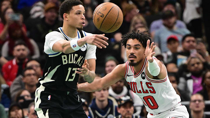 Nov 7, 2025; Milwaukee, Wisconsin, USA;  Milwaukee Bucks guard Ryan Rollins (13) passes the ball away from Chicago Bulls guard Tre Jones (30) in the second quarter at Fiserv Forum. Mandatory Credit: Benny Sieu-Imagn Images