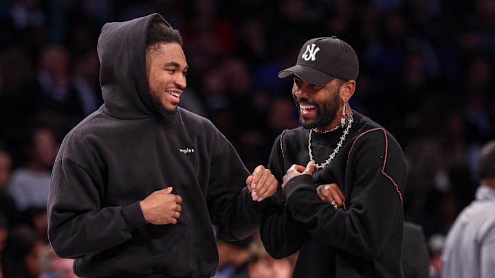 Mar 24, 2025; Brooklyn, New York, USA; Brooklyn Nets guard Cam Thomas, left, talks with Dallas Mavericks guard Kyrie Irving (11) during the first quarter at Barclays Center. Mandatory Credit: Vincent Carchietta-Imagn Images