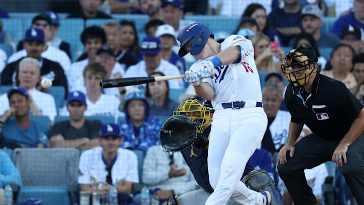 Oct 16, 2025; Los Angeles, California, USA; Los Angeles Dodgers catcher Will Smith (16) hits a single against the Milwaukee Brewers in the sixth inning during game three of the NLCS round for the 2025 MLB playoffs at Dodger Stadium. Mandatory Credit: Kiyoshi Mio-Imagn Images