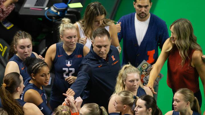 Illinois coach Chris Tamas, center, brings his team together during the first set against the Oregon Ducks Illinois coach Chris Tamas, center, brings his team together during the first set against the Oregon Ducks