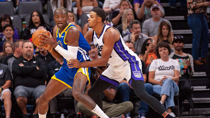 Oct 9, 2024; Sacramento, California, USA; Sacramento Kings forward Keegan Murray (13) defends against Golden State Warriors forward Jonathan Kuminga (00) during the first quarter at Golden 1 Center. Mandatory Credit: Ed Szczepanski-Imagn Images