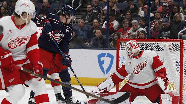 Jan 2, 2025; Columbus, Ohio, USA; Columbus Blue Jackets left wing Dmitri Voronkov (10) tips a puck on goal against the Detroit Red Wings during the first period at Nationwide Arena. Mandatory Credit: Russell LaBounty-Imagn Images