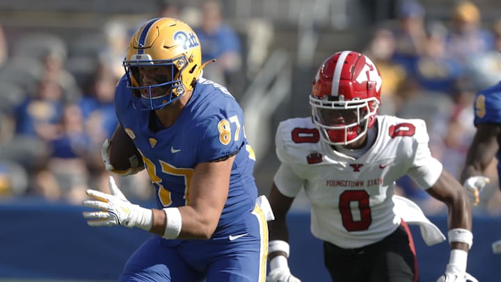 Sep 21, 2024; Pittsburgh, Pennsylvania, USA;  Pittsburgh Panthers tight end Jake Overman (87) runs after a pass reception against Youngstown State Penguins defensive back Isaiah Crozier (0) during the second quarter at Acrisure Stadium. Mandatory Credit: Charles LeClaire-Imagn Images