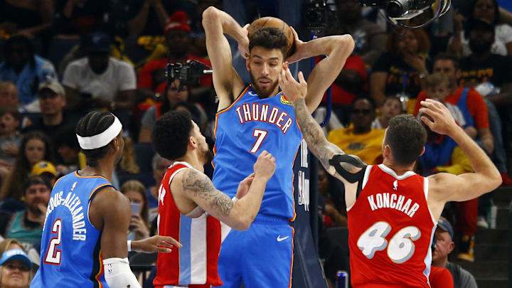 Apr 26, 2025; Memphis, Tennessee, USA; Oklahoma City Thunder forward Chet Holmgren (7) collects a rebound over Memphis Grizzlies guard Scotty Pippen Jr. (1) and guard John Konchar (46) during the fourth quarter during game four for the first round of the 2024 NBA Playoffs at FedExForum. Mandatory Credit: Petre Thomas-Imagn Images