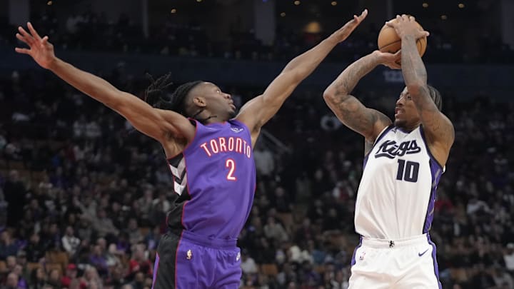 Nov 2, 2024; Toronto, Ontario, CAN; Toronto Raptors forward Jonathan Mogbo (2) tries to block a shot by Sacramento Kings forward DeMar DeRozan (10) during overtime at Scotiabank Arena. Mandatory Credit: John E. Sokolowski-Imagn Images