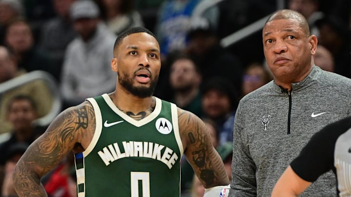 Nov 20, 2024; Milwaukee, Wisconsin, USA;  Milwaukee Bucks guard Damian Lillard (0) looks on with head coach Doc Rivers during a timeout in the fourth quarter against the Chicago Bulls at Fiserv Forum. Mandatory Credit: Benny Sieu-Imagn Images