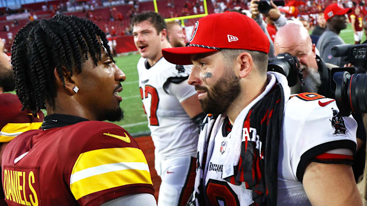 Sep 8, 2024; Tampa, Florida, USA; Washington Commanders quarterback Jayden Daniels (5) and Tampa Bay Buccaneers quarterback Baker Mayfield (6) greet after the game at Raymond James Stadium. Mandatory Credit: Kim Klement Neitzel-Imagn Images