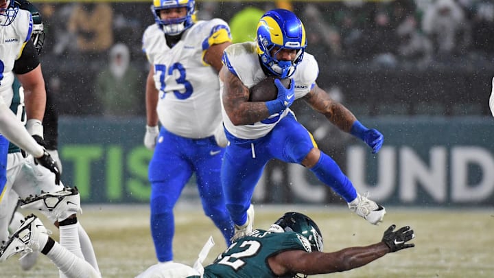 Jan 19, 2025; Philadelphia, Pennsylvania, USA; Los Angeles Rams running back Kyren Williams (23) leaps over Philadelphia Eagles linebacker Oren Burks (42) during the third quarter against the Philadelphia Eagles in a 2025 NFC divisional round game at Lincoln Financial Field. Mandatory Credit: Eric Hartline-Imagn Images