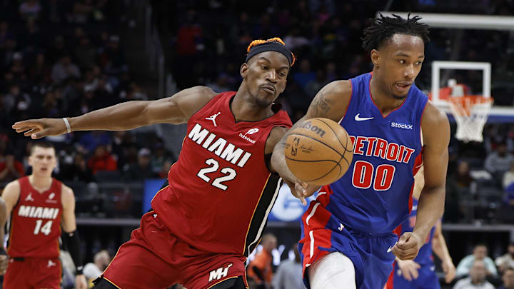 Dec 16, 2024; Detroit, Michigan, USA;  Miami Heat forward Jimmy Butler (22) knocks the ball away from Detroit Pistons forward Ronald Holland II (00) in the second half at Little Caesars Arena. Mandatory Credit: Rick Osentoski-Imagn Images