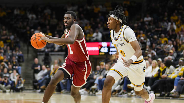 Feb 12, 2025; Columbia, Missouri, USA; Oklahoma Sooners guard Kobe Elvis (1) drives against Missouri Tigers guard Anthony Robinson II (0) during the second half at Mizzou Arena. Mandatory Credit: Jay Biggerstaff-Imagn Images