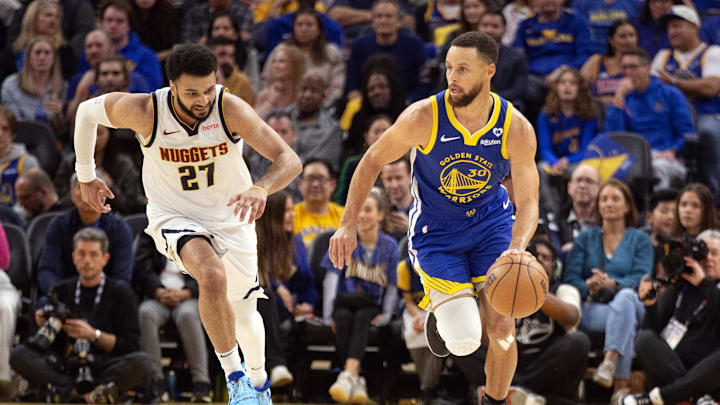 Denver Nuggets guard Jamal Murray (27) chases Golden State Warriors guard Stephen Curry (30) as he brings the ball up court during the second quarter at Chase Center. Mandatory Credit: D. Ross Cameron-Imagn Images