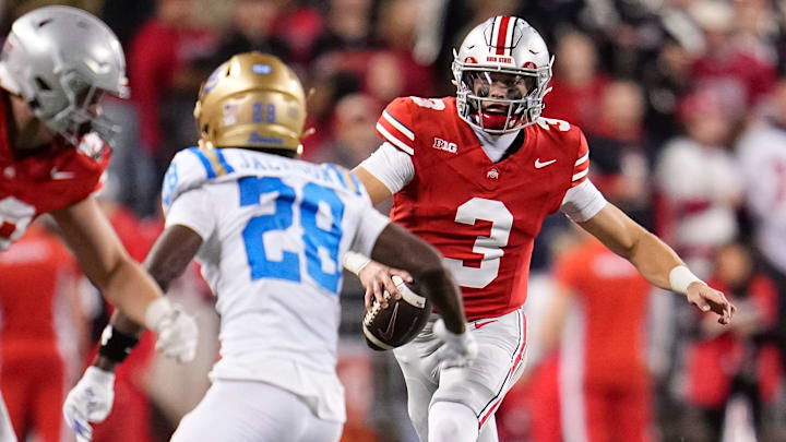 Ohio State Buckeyes quarterback Lincoln Kienholz (3) runs at UCLA Bruins defensive back Scooter Jackson (28) during the NCAA football game at Ohio Stadium in Columbus on Nov. 15, 2025. Ohio State won 48-10.