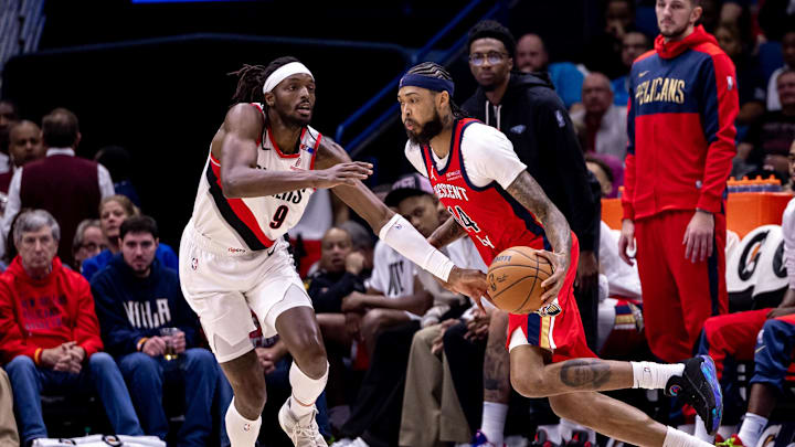 Nov 4, 2024; New Orleans, Louisiana, USA;  New Orleans Pelicans forward Brandon Ingram (14) dribbles against Portland Trail Blazers forward Jerami Grant (9) during the first half at Smoothie King Center. Mandatory Credit: Stephen Lew-Imagn Images