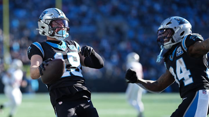 Dec 22, 2024; Charlotte, North Carolina, USA; Carolina Panthers wide receiver Adam Thielen (19) and running back Mike Boone (34) celebrate Thielen scoring a touchdown catch against the Arizona Cardinals during the second quarter at Bank of America Stadium.