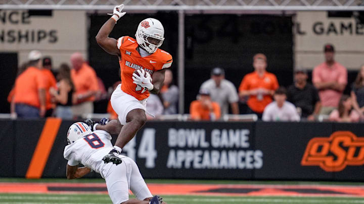 Oklahoma State running back Kalib Hicks (1) hurdles over Tennessee Martin cornerback JaMichael McGoy Jr. (8) in the first quarter during an NCAA football game between Oklahoma State (OSU) and UT Martin in Stillwater, Okla., on Thursday, Aug. 28, 2025. Oklahoma State running back Kalib Hicks (1) hurdles over Tennessee Martin cornerback JaMichael McGoy Jr. (8) in the first quarter during an NCAA football game between Oklahoma State (OSU) and UT Martin in Stillwater, Okla., on Thursday, Aug. 28, 2025.