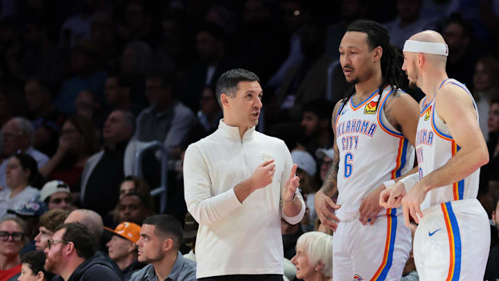 Jan 17, 2026; Miami, Florida, USA; Oklahoma City Thunder head coach Mark Daigneault speaks to forward Jaylin Williams (6), guard Alex Caruso (9), and guard Shai Gilgeous-Alexander (2) against the Miami Heat during the fourth quarter at Kaseya Center. Mandatory Credit: Sam Navarro-Imagn Images