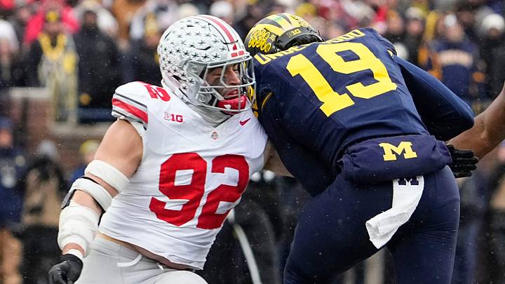 Ohio State Buckeyes defensive end Caden Curry (92) hits Michigan Wolverines quarterback Bryce Underwood (19) during the NCAA football game at Michigan Stadium in Ann Arbor, Mich. on Nov. 29, 2025. Ohio State won 27-9.