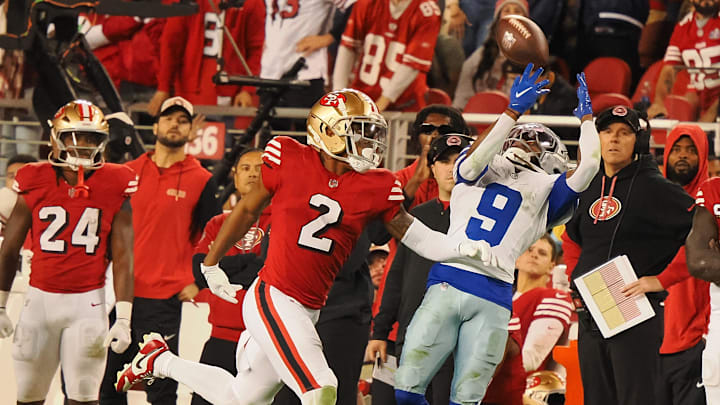 Oct 27, 2024; Santa Clara, California, USA; San Francisco 49ers defensive back Deommodore Lenoir (2) prevents the pass intended fo rDallas Cowboys wide receiver KaVonte Turpin (9) as San Francisco 49ers quarterback Brock Purdy (13) watches from the bench during the fourth quarter at Levi's Stadium. Mandatory Credit: Kelley L Cox-Imagn Images