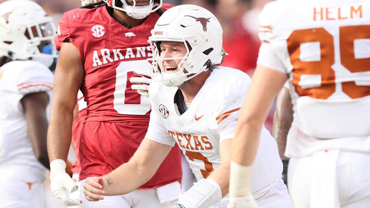 Nov 16, 2024; Fayetteville, Arkansas, USA; Texas Longhorns quarterback Quinn Ewers (3) celebrates after making a final first down to end the game against the Arkansas Razorbacks at Donald W. Reynolds Razorback Stadium. Texas won 20-10. Mandatory Credit: Nelson Chenault-Imagn Images