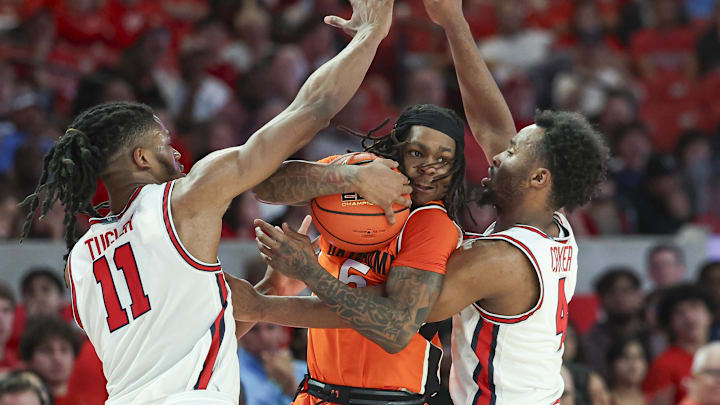 Feb 4, 2025; Houston, Texas, USA; Oklahoma State Cowboys guard Khalil Brantley (5) is defended by Houston Cougars forward Joseph Tugler (11) and guard L.J. Cryer (4) during the second half at Fertitta Center. Mandatory Credit: Troy Taormina-Imagn Images