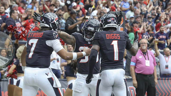 Sep 29, 2024; Houston, Texas, USA; Houston Texans running back Dare Ogunbowale (33) celebrates with quarterback C.J. Stroud (7) and wide receiver Stefon Diggs (1) after scoring a touchdown during the fourth quarter against the Jacksonville Jaguars at NRG Stadium. Mandatory Credit: Troy Taormina-Imagn Images