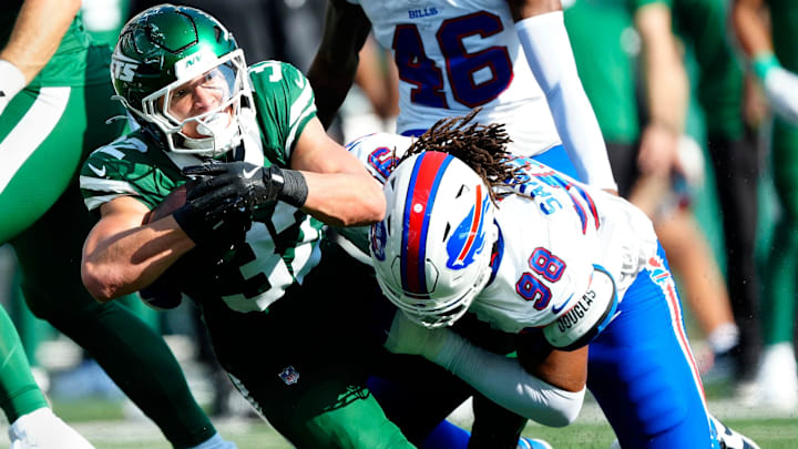 New York Jets running back Isaiah Davis (32) is tackled by Buffalo Bills defensive tackle T.J. Sanders (98), Sunday, September 14, 2025, in East Rutherford.