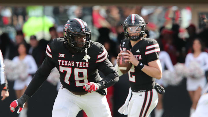 Nov 30, 2024; Lubbock, Texas, USA;  Texas Tech Red Raiders offensive guard Sterling Porcher (79) blocks for quarterback Behren Morton (2) in the second half during the game against the West Virginia Mountaineers at Jones AT&T Stadium and Cody Campbell Field. Mandatory Credit: Michael C. Johnson-Imagn Images