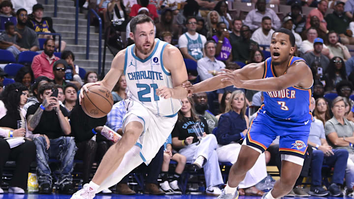 Oct 5, 2025; North Charleston, South Carolina, USA; Pat Charlotte Hornets Connaughton (21) drives to the basket against Oklahoma City Thunder guard Chris Youngblood (3) in the fourth quarter at North Charleston Coliseum. Mandatory Credit: Arthur Ellis-Imagn Images