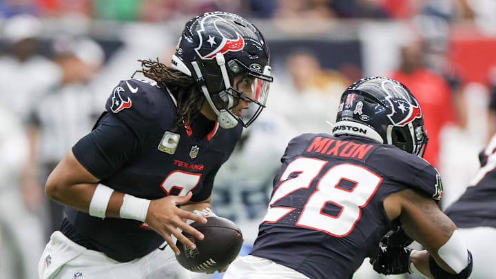 Nov 24, 2024; Houston, Texas, USA;  Houston Texans quarterback C.J. Stroud (7) fakes the hand-off to Houston Texans running back Joe Mixon (28) in the first quarter at NRG Stadium. Mandatory Credit: Thomas Shea-Imagn Images