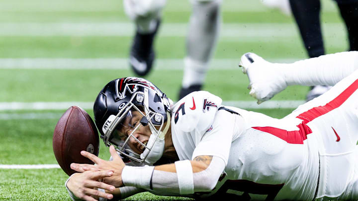 Jan 7, 2024; New Orleans, Louisiana, USA; Atlanta Falcons quarterback Desmond Ridder (9) looks the football for a fumble as New Orleans Saints defensive end Payton Turner (98) recovers it during the second half at Caesars Superdome. Mandatory Credit: Stephen Lew-Imagn Images
