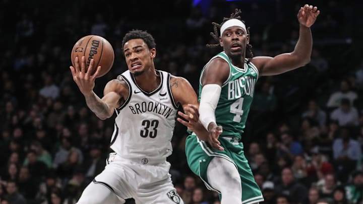 Feb 13, 2024; Brooklyn, New York, USA;  Brooklyn Nets center Nic Claxton (33) and Boston Celtics guard Jrue Holiday (4) fight for a loose ball in the third quarter at Barclays Center. Mandatory Credit: Wendell Cruz-Imagn Images