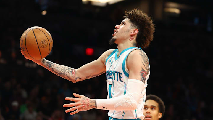 Jan 12, 2025; Phoenix, Arizona, USA; Charlotte Hornets guard LaMelo Ball (1) shoots the ball against Phoenix Suns center Oso Ighodaro (4) during the second half at Footprint Center. Mandatory Credit: Mark J. Rebilas-Imagn Images