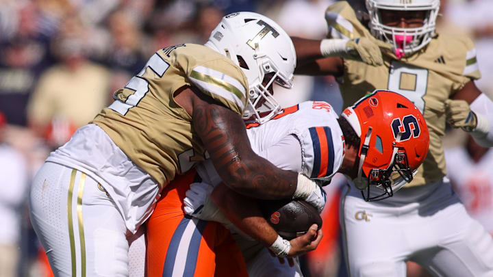 Oct 25, 2025; Atlanta, Georgia, USA; Georgia Tech Yellow Jackets defensive lineman Jason Moore (95) forces Syracuse Orange quarterback Rickie Collins (10) to fumble in the third quarter at Bobby Dodd Stadium at Hyundai Field. Mandatory Credit: Brett Davis-Imagn Images
