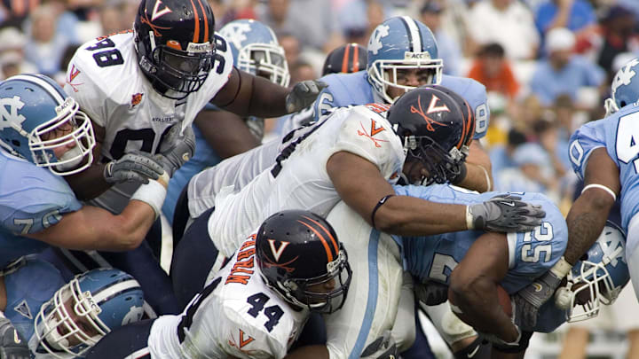 October 22, 2005; Chapel Hill, NC, USA; North Carolina Tar Heels tailback #25 Ronnie McGill is tackled by Virginia Cavalier linebacker #34 Ahmad Brooks and linebacker #44 Kai Parham in the Tar Heels 7-5 victory over the Virginia Cavaliers at Kenan Stadium. Mandatory Credit: Bob Donnan-Imagn Images Copyright © 2005 Bob Donnan October 22, 2005; Chapel Hill, NC, USA; North Carolina Tar Heels tailback #25 Ronnie McGill is tackled by Virginia Cavalier linebacker #34 Ahmad Brooks and linebacker #44 Kai Parham in the Tar Heels 7-5 victory over the Virginia Cavaliers at Kenan Stadium. Mandatory Credit: Bob Donnan-Imagn Images Copyright © 2005 Bob Donnan